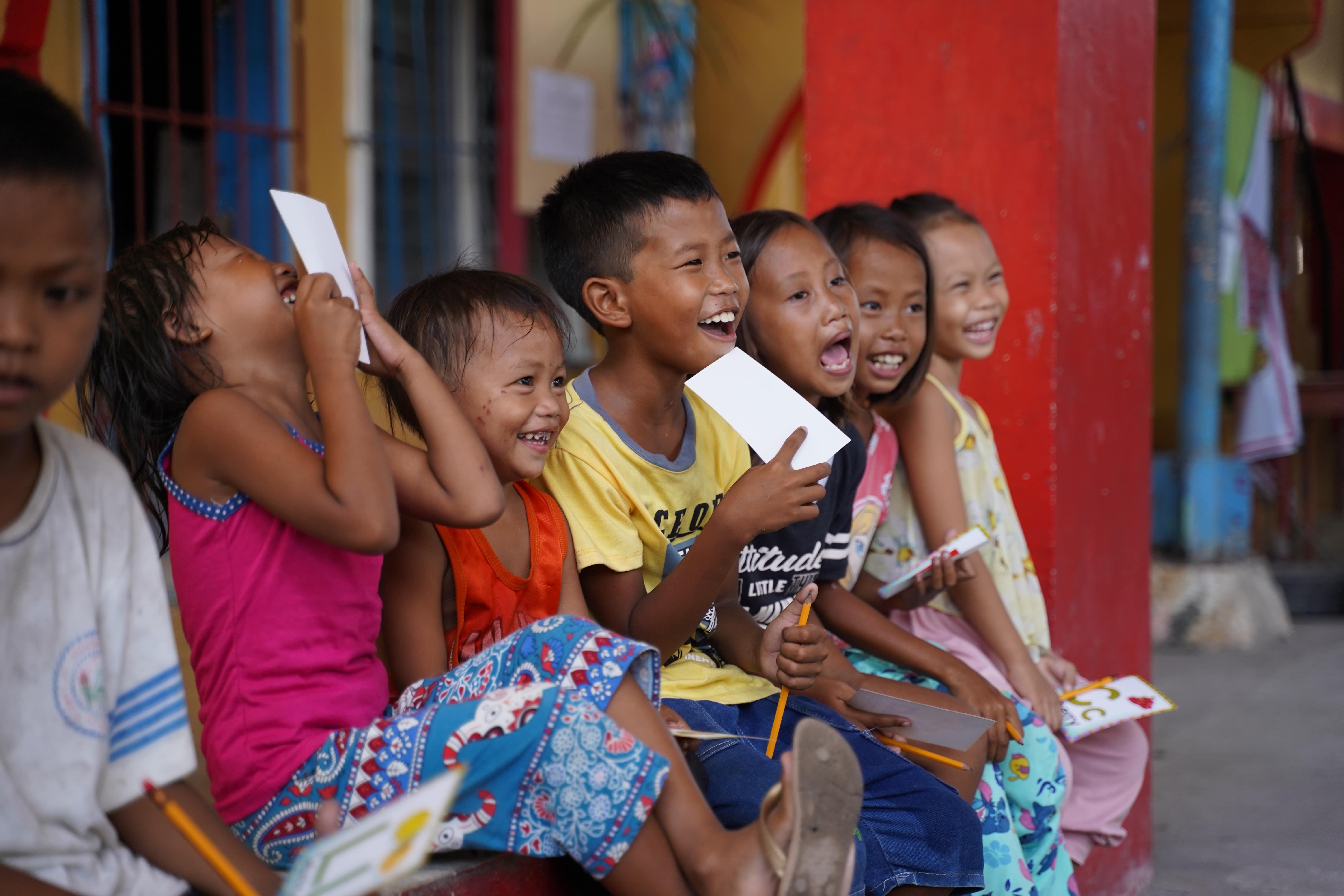 Children smiling and laughing while participating in an FFEC activity