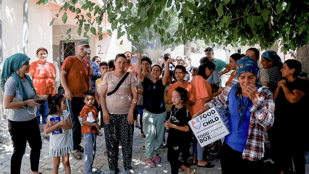 Victims of the earthquake in Turkey line up to receive aid from Food For Every Child