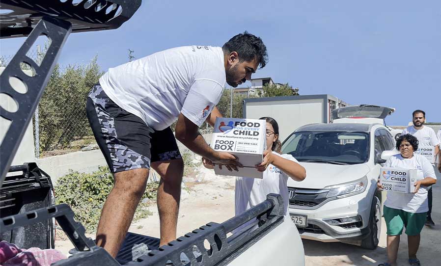 Food For Every Child Volunteer In Turkey Loading Truck with Food Boxes
