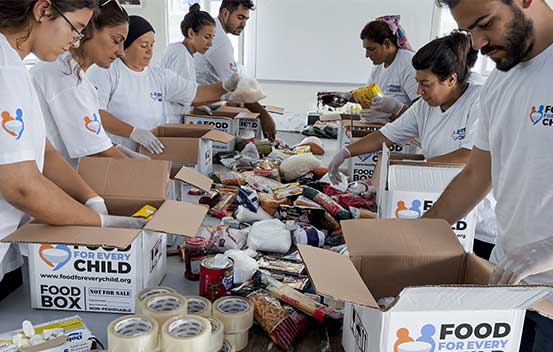 Food For Every Child Volunteers in Turkey packing boxes with emergency food items for earthquake victims