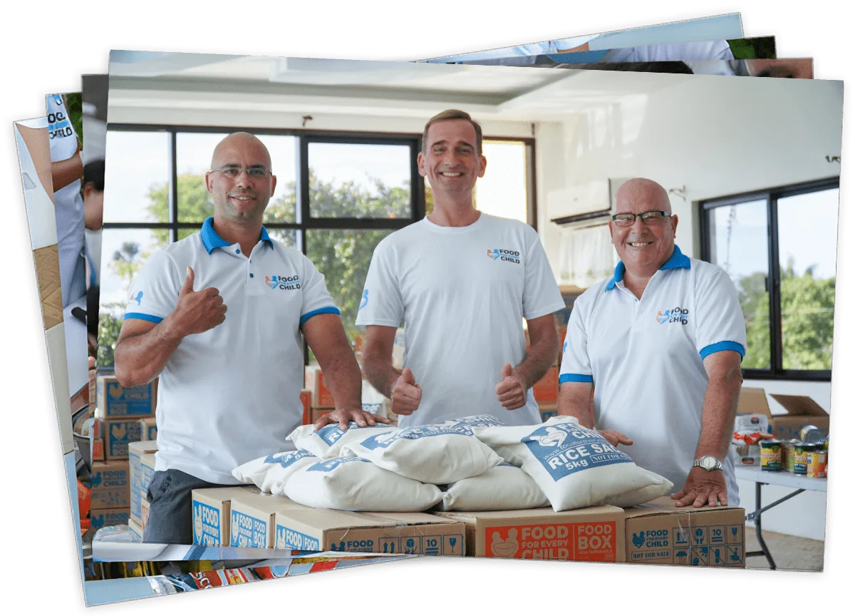 Volunteers standing in front of packed boxes and rice sacks